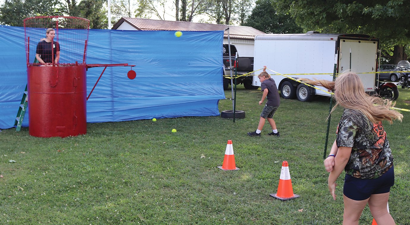 Crawfordsville Police Department Sgt. Jennifer Haslam, left, awaits the results of a throw by Forman Fundraiser visitor Taelyn Stephens.